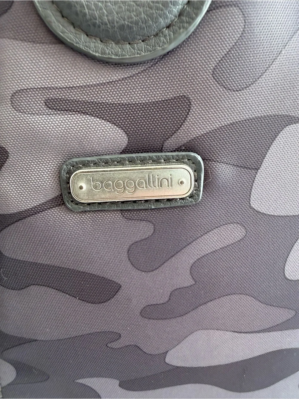 Baggallini MM Metro Backpack in a Dark Gray Camo print.